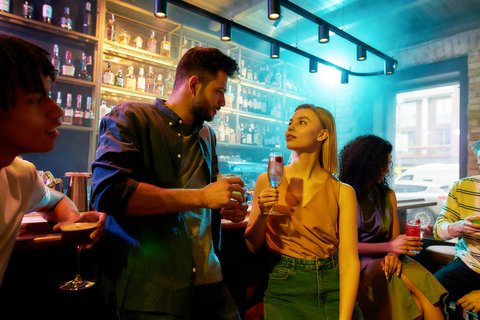 man talking with woman in a bar